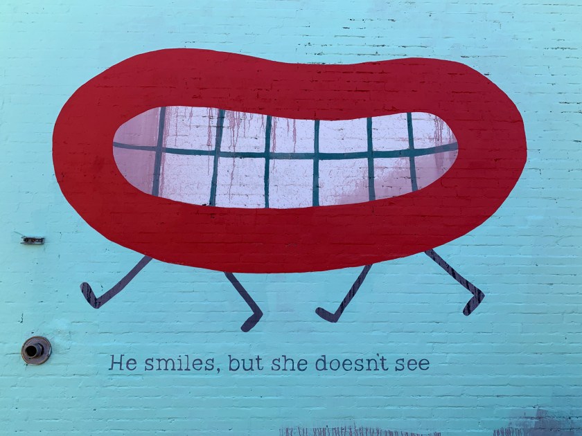 He smiles, but she doesn't see
